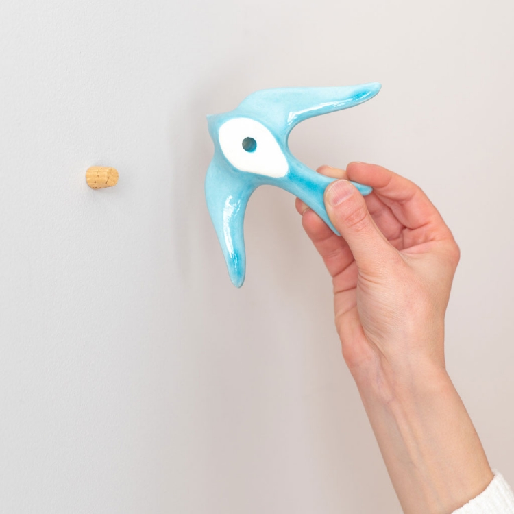 Hanging ceramic swallows on the wall